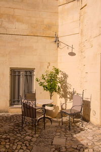 Chairs and table against wall in building