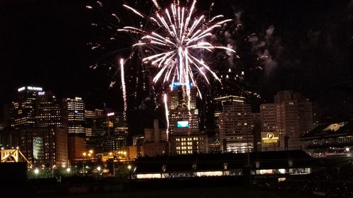 Low angle view of firework display at night