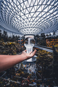 Man holding glass of building