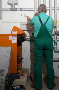 Rear view of man working at construction site