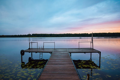 Pier on lake against sky