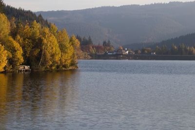 Scenic view of lake by mountain against sky
