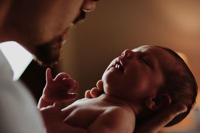 Close-up of couple touching baby