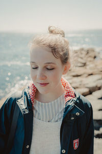 Close-up of young woman standing at beach