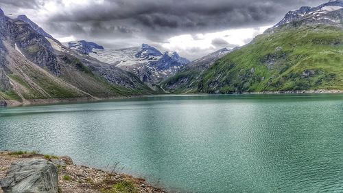 Scenic view of lake and mountains against sky