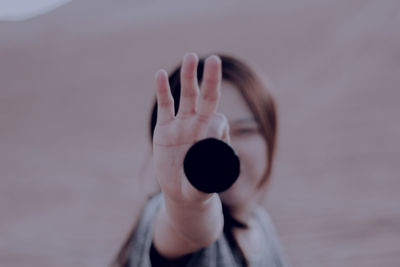 Cropped image of woman hand against blurred background