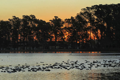 Scenic view of lake against sky during sunset