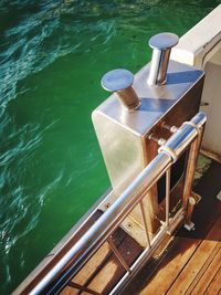 High angle view of empty chairs on pier at lake