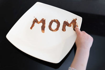 Midsection of person holding ice cream in plate