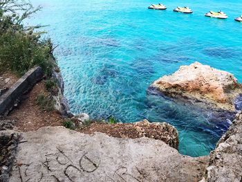 High angle view of rocks on sea shore