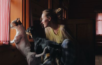View of woman with dogs at home