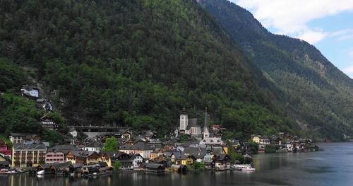 Scenic view of river by buildings in town