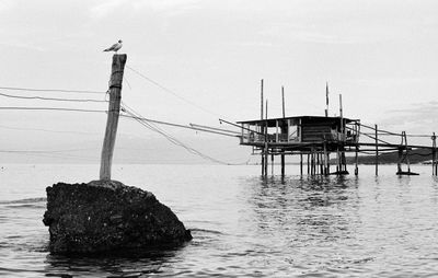 Lifeguard hut on sea against sky