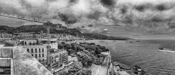 High angle view of sea and buildings against sky