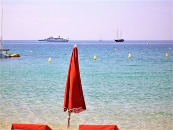 Sailboat in sea against clear sky