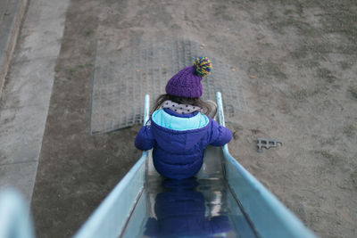 High angle view of girl on slide in playground