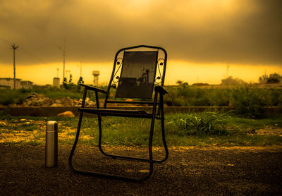 Abandoned chair against sky