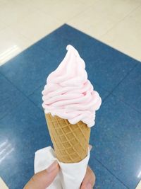 Close-up of hand holding ice cream cone