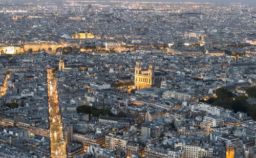 Aerial view of paris at dusk with the city illuminated