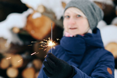 Portrait of girl holding sparkler