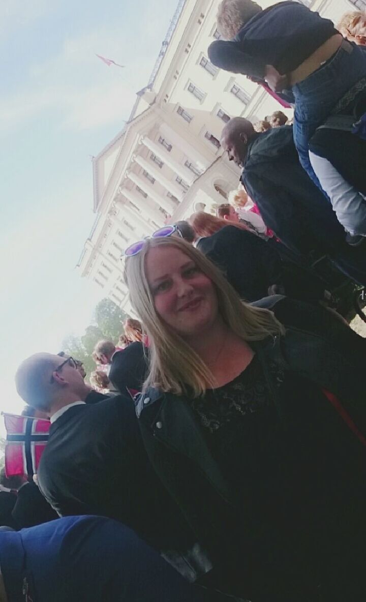 LOW ANGLE VIEW OF YOUNG WOMAN STANDING IN PARK