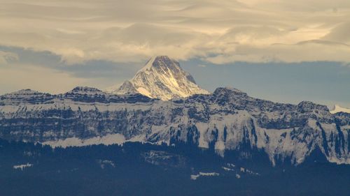 Scenic view of snowcapped mountains against sky during sunset