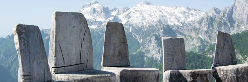 Panoramic view of wooden posts in mountains against sky