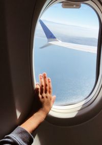 Man seen through airplane window