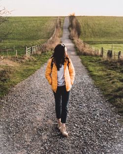 Full length of woman walking on road