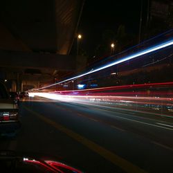 Light trails on road in city at night