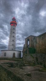 Low angle view of lighthouse against cloudy sky