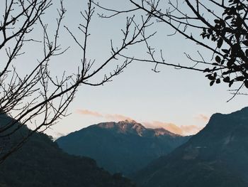 Scenic view of mountains against sky at sunset