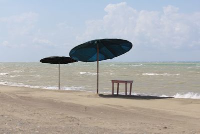 Lifeguard hut on beach against sky