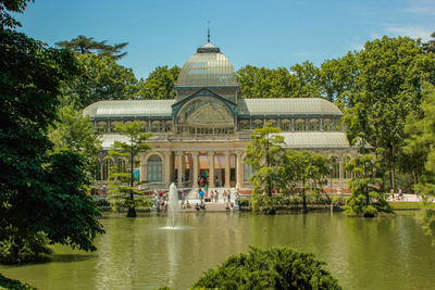 Front view of the crystal palace with its lake in the parque del retiro, madrid, spain