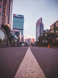 View of city street and buildings against sky