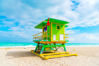 Lifeguard hut on beach against sky