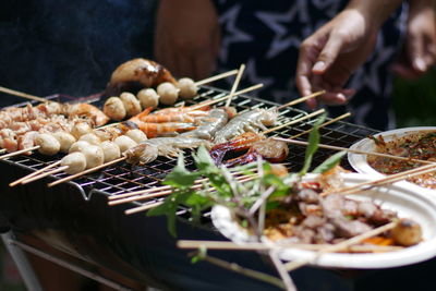 Close-up of preparing food on barbecue grill