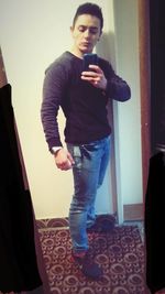 Full length of woman photographing through smart phone