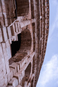 Low angle view of old building against cloudy sky