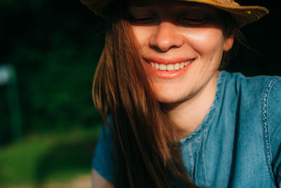 Close-up portrait of smiling young woman