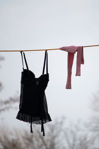 Low angle view of clothes drying on clothesline against sky