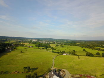 High angle view of green landscape against sky