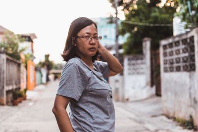 Portrait of young woman looking at city