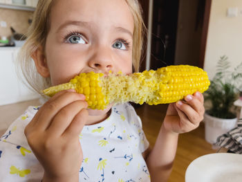 Close-up of woman holding corn