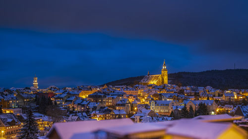 Illuminated cityscape against sky at night in schneeberg in the ore mountains on christmas time 