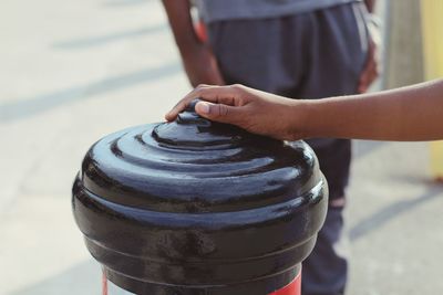 Cropped hand touching fire hydrant