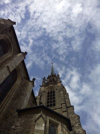 Low angle view of church against cloudy sky