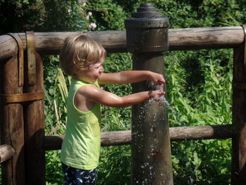 Side view of smiling girl in water