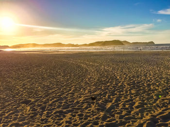 Scenic view of beach against sky during sunset