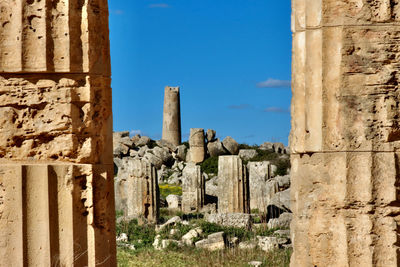 Old ruins of building against blue sky